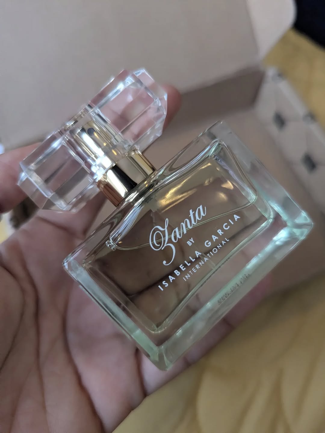 A fragrance bottle held up to the light
